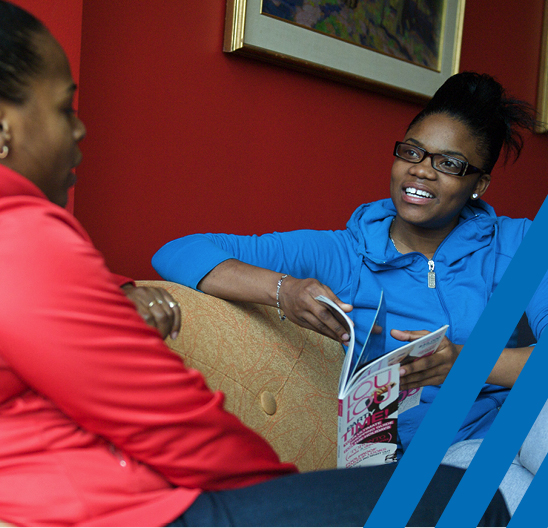 two diverse women sitting having a conversation