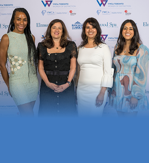 four women standing together in a line smiling